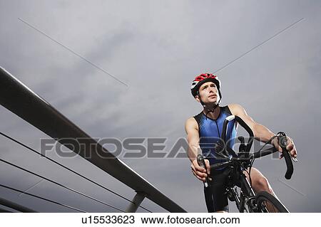 Cyclist riding on foot bridge, low angle view View Large Photo Image Stock Image - Cyclist riding on foot bridge, low angle view. Fotosearch