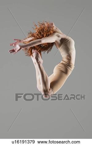 Dancer jumps with arms and legs bending backwards View Large Photo Image Stock Photo - Dancer jumps with arms and legs bending backwards. Fotosearch