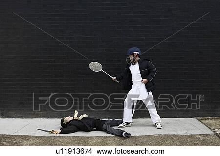 Picture - Dressed up boys pretending to fight. Fotosearch