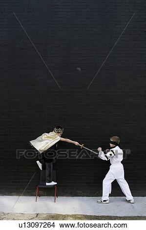 Dressed up boys pretending to fight View Large Photo Image Picture - Dressed up boys pretending to fight. Fotosearch