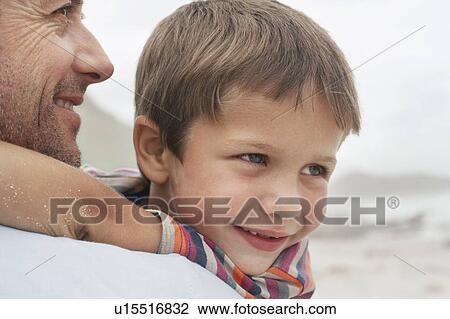 Father carrying son (5-6) on beach, close-up View Large Photo Image Stock Image - Father carrying son (5-6) on beach, close-up. Fotosearch