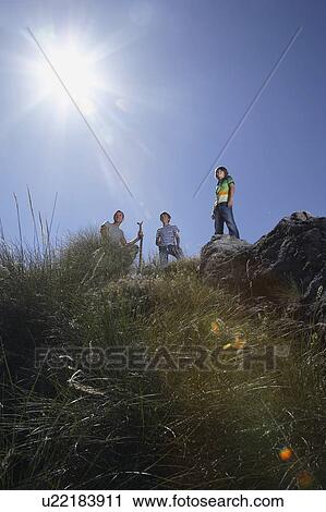Father with two sons (7-9, 10-12) on mountain top, low angle view View Large Photo Image Stock Image - Father with two sons (7-9, 10-12) on mountain top, low angle view. Fotosearch