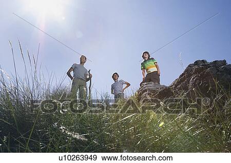 Father with two sons (7-9, 10-12) on mountain top, low angle view View Large Photo Image Stock Photo - Father with two sons (7-9, 10-12) on mountain top, low angle view. Fotosearch