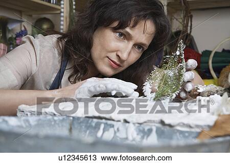 Stock Image - Female artist working in studio. Fotosearch