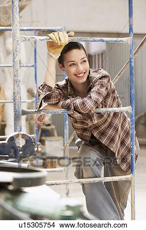 Female interior decorator leaning on Scaffolding View Large Photo Image Picture - Female interior decorator leaning on Scaffolding. Fotosearch