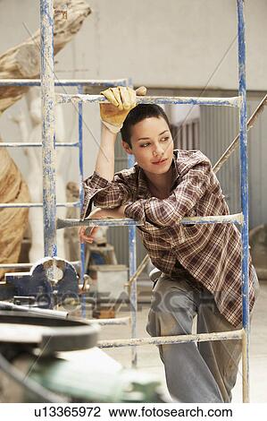 Female interior decorator leaning on Scaffolding View Large Photo Image Stock Image - Female interior decorator leaning on Scaffolding. Fotosearch