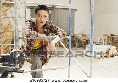 Female interior decorator leaning on Scaffolding, portrait View Large Photo Image Stock Photo - Female interior decorator leaning on Scaffolding, portrait. Fotosearch