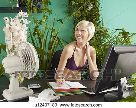Female office worker wearing bikini sitting behind desk View Large Photo Image Stock Photo - Female office worker wearing bikini sitting behind desk. Fotosearch