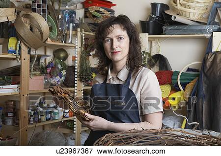 Stock Photo - Florist in her shop, portrait. Fotosearch