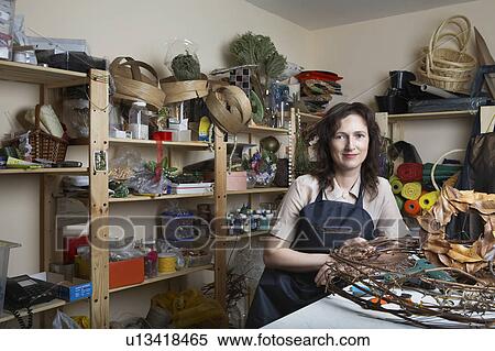 Stock Photography - Florist in shop with wreath, portrait. Fotosearch