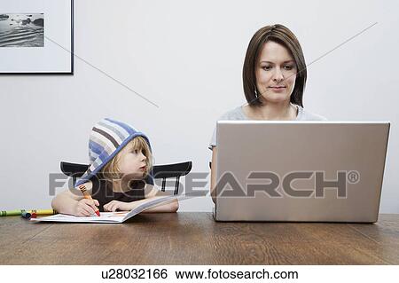 Girl (3-4) assisting mother using laptop View Large Photo Image Stock Photograph - Girl (3-4) assisting mother using laptop. Fotosearch