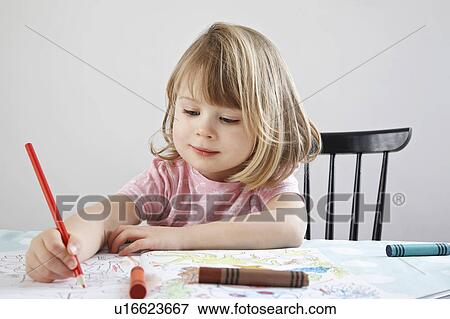 Stock Photo - Girl (3-4) colouring in book. Fotosearch