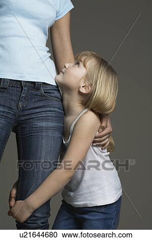 Stock Image - Girl (3-4) embracing mother (mid section). Fotosearch
