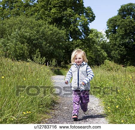 Girl (3-4) running on path in countryside View Large Photo Image Stock Photograph - Girl (3-4) running on path in countryside. Fotosearch