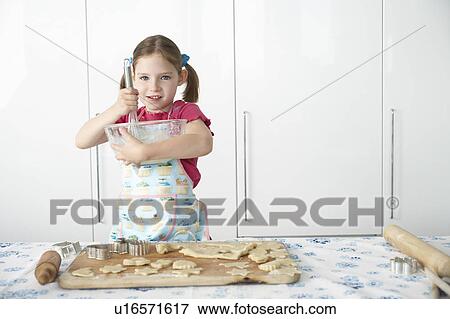 Girl (5-6) preparing cookies in kitchen View Large Photo Image Stock Photo - Girl (5-6) preparing cookies in kitchen. Fotosearch
