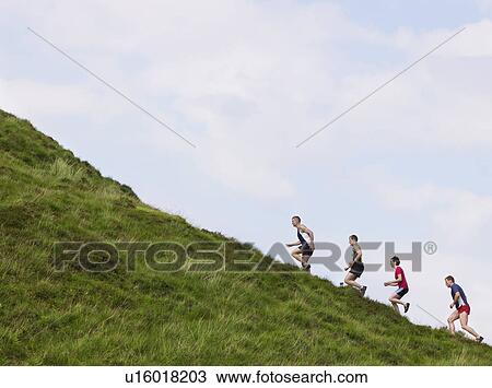 Group running up hillside View Large Photo Image Stock Image - Group running up hillside. Fotosearch