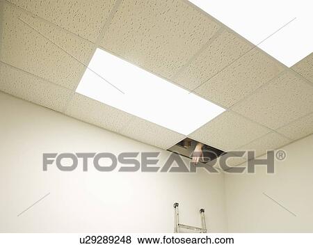 Stock Photo - Hand reaching from hole in ceiling. Fotosearch