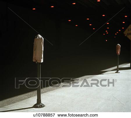 Stock Photo - Hooded parking meters on empty roadside. Fotosearch