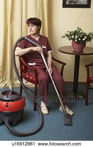 Hotel Housekeeper Resting in Chair View Large Photo Image Stock Image - Hotel Housekeeper Resting in Chair. Fotosearch
