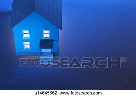Stock Image - Illuminated model house. Fotosearch