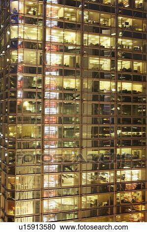 Stock Image - Illuminated office building facade. Fotosearch