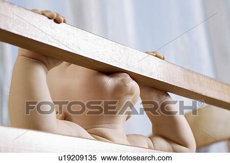 Infant child biting cot View Large Photo Image Stock Photography - Infant child biting cot. Fotosearch