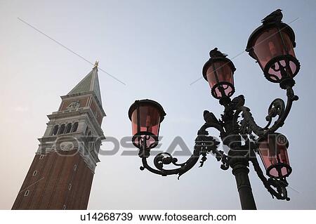 Stock Photo - Italy, Venice, San Giorgio Maggiore tower and lamp post, low angle view. Fotosearch