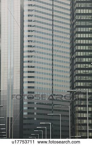 Stock Image - Japan, Tokyo, Shinjuku, office building exteriors, close-up. Fotosearch