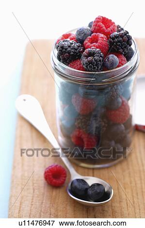 Jar full of raspberries, blackberries and blueberries on cutting board View Large Photo Image Stock Photo - Jar full of raspberries, blackberries and blueberries on cutting board. Fotosearch