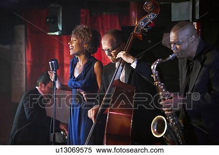 Jazz band performing in nightclub View Large Photo Image Stock Photography - Jazz band performing in nightclub. Fotosearch