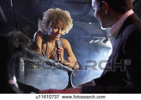 Jazz singer and pianist on stage, low angle view View Large Photo Image Stock Photo - Jazz singer and pianist on stage, low angle view. Fotosearch