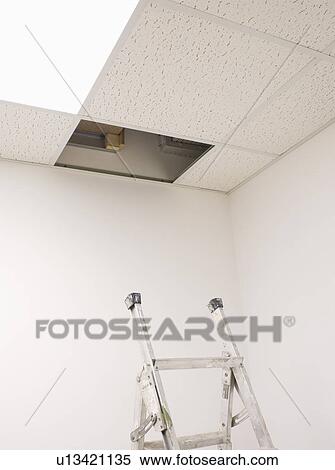 Ladder In Below Open Ceiling Panel In Empty Office Stock Photography