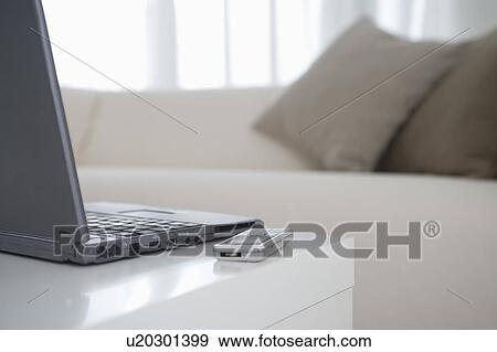 Stock Photo - Laptop and cell phone on table. Fotosearch