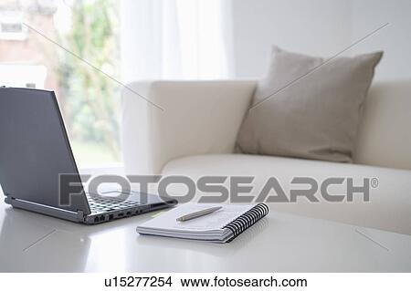 Picture - Laptop and notebook on table. Fotosearch