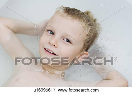 Stock Photo - Little Boy Floating in Bathtub. Fotosearch