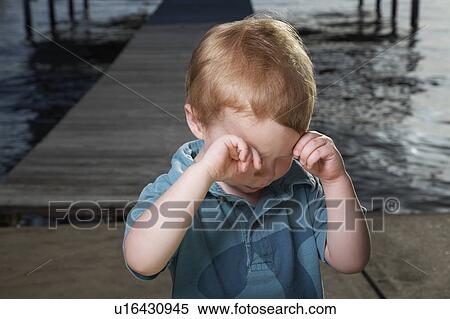 Little Boy on Pier Rubbing His Eyes View Large Photo Image Stock Photography - Little Boy on Pier Rubbing His Eyes. Fotosearch