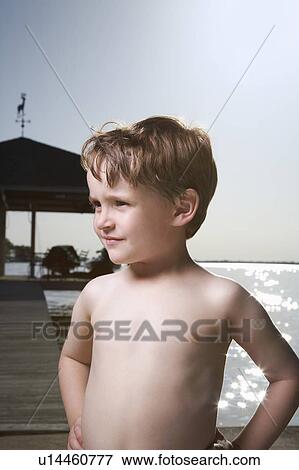 Stock Photo - Little Boy Standing on Pier. Fotosearch