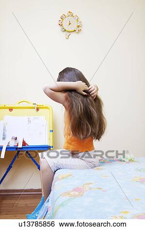 Stock Photograph - Little Girl Combing Her Hair. Fotosearch