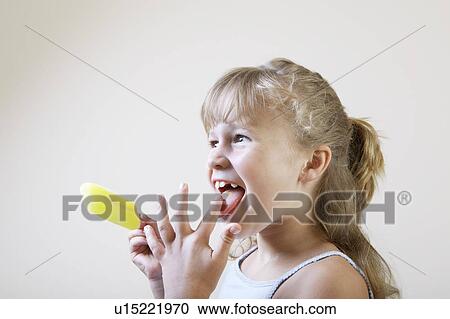 Stock Image - Little Girl Eating a Popsicle. Fotosearch