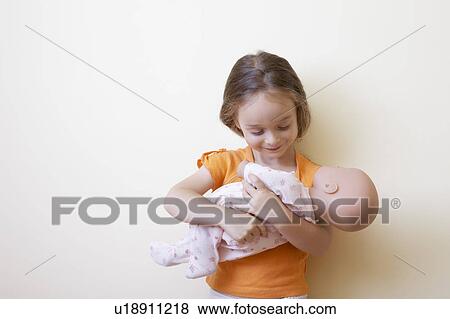 Stock Photo - Little Girl Holding Doll. Fotosearch