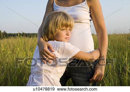 Little Girl Hugging Her Mother in a Field View Large Photo Image Stock Photo - Little Girl Hugging Her Mother in a Field. Fotosearch