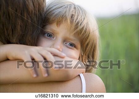 Stock Image - Little Girl Hugging Her Mother. Fotosearch