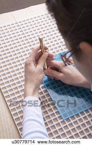 Man cuts blue glass with scalpel View Large Photo Image Picture - Man cuts blue glass with scalpel. Fotosearch