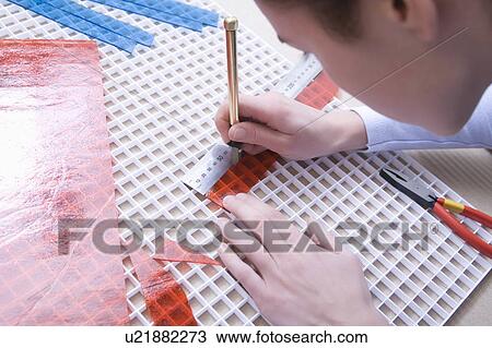 Man cuts red glass with scalpel View Large Photo Image Stock Image - Man cuts red glass with scalpel. Fotosearch
