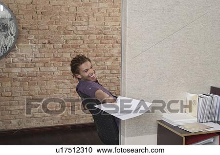 Man handing papers in office View Large Photo Image Stock Image - Man handing papers in office. Fotosearch