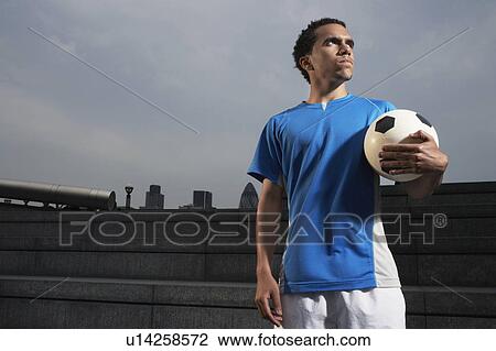 Man holding soccer ball, outdoors View Large Photo Image Stock Image - Man holding soccer ball, outdoors. Fotosearch