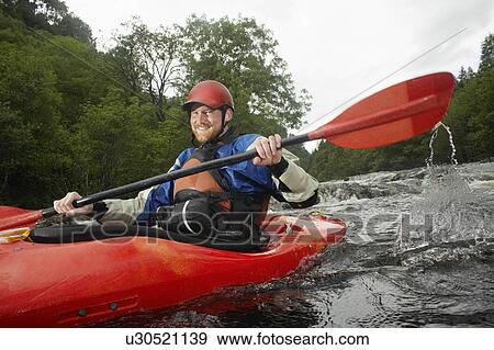 Man kayaking in river, portrait View Large Photo Image Stock Photo - Man kayaking in river, portrait. Fotosearch