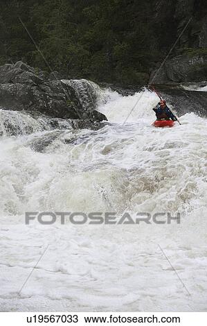 Stock Image - Man kayaking in river. Fotosearch