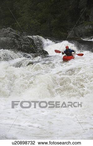 Stock Image - Man kayaking in river. Fotosearch