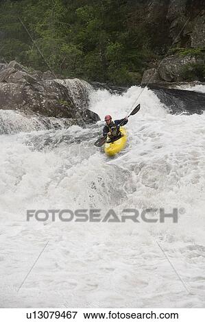 Man kayaking in river View Large Photo Image Stock Photo - Man kayaking in river. Fotosearch